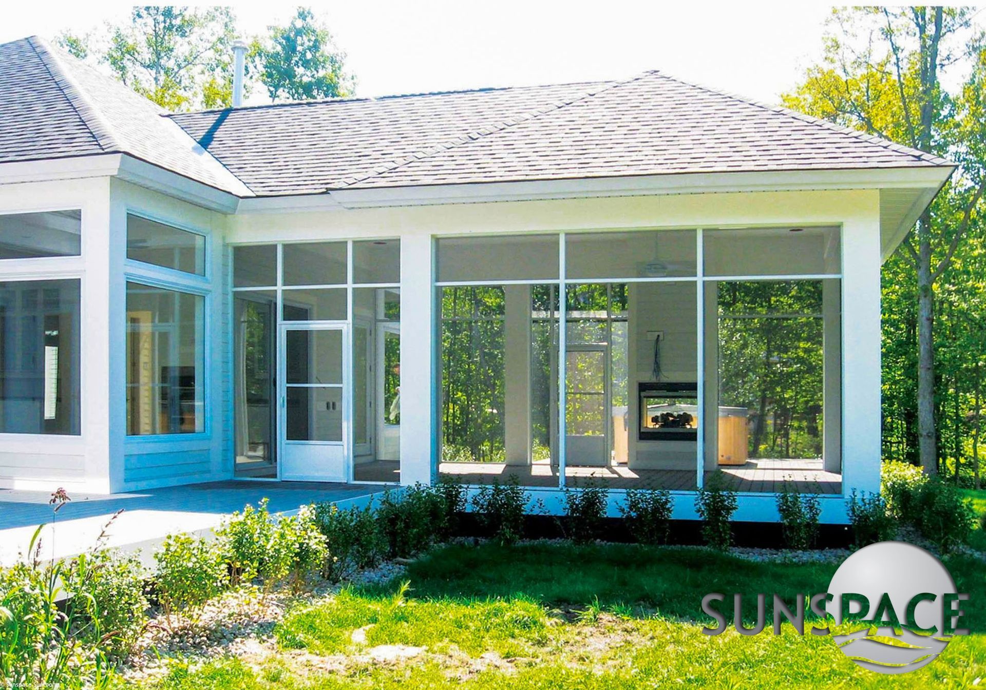 A house with a screened in porch and a sunspace logo