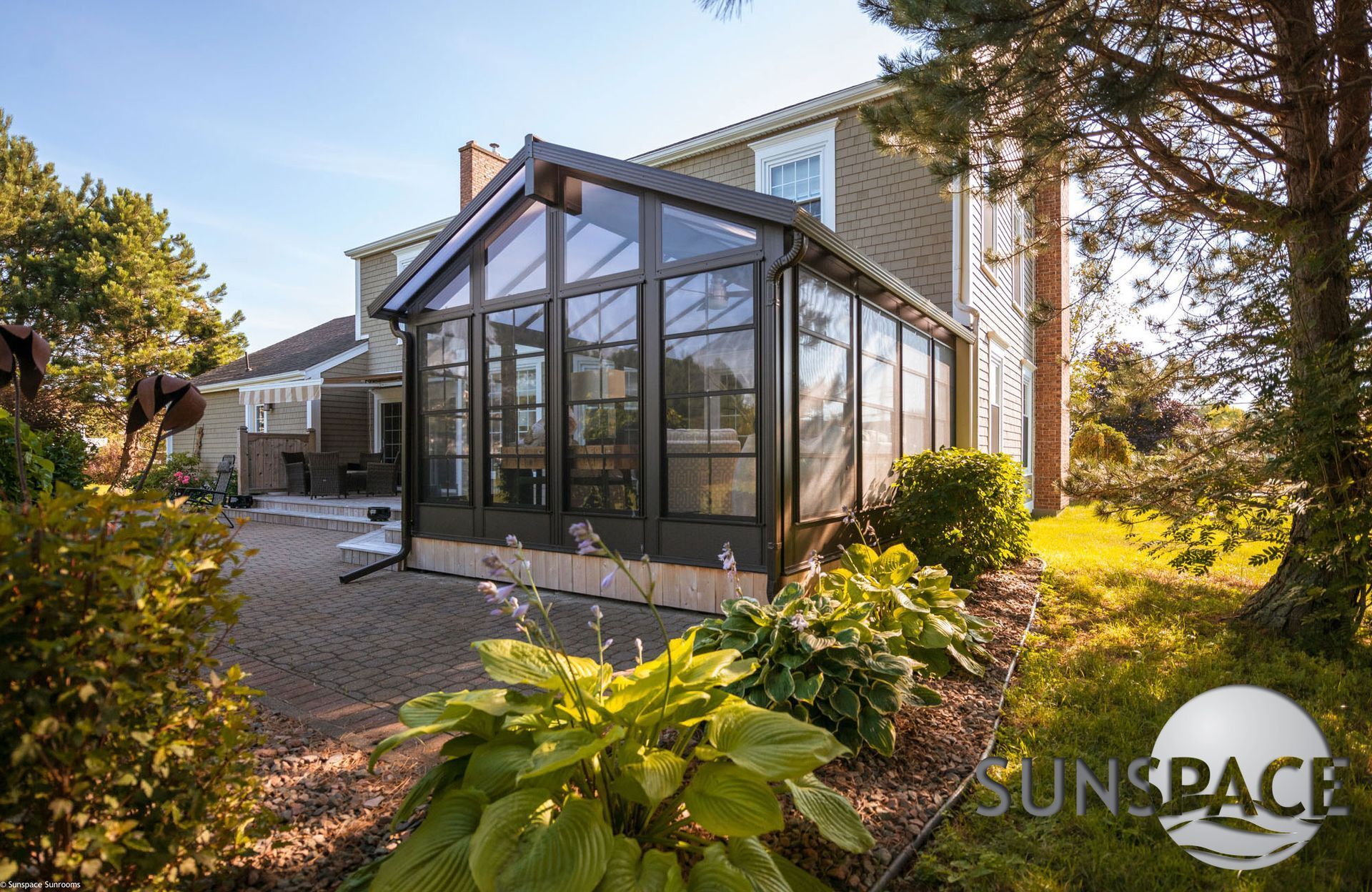A large house with a greenhouse attached to it.