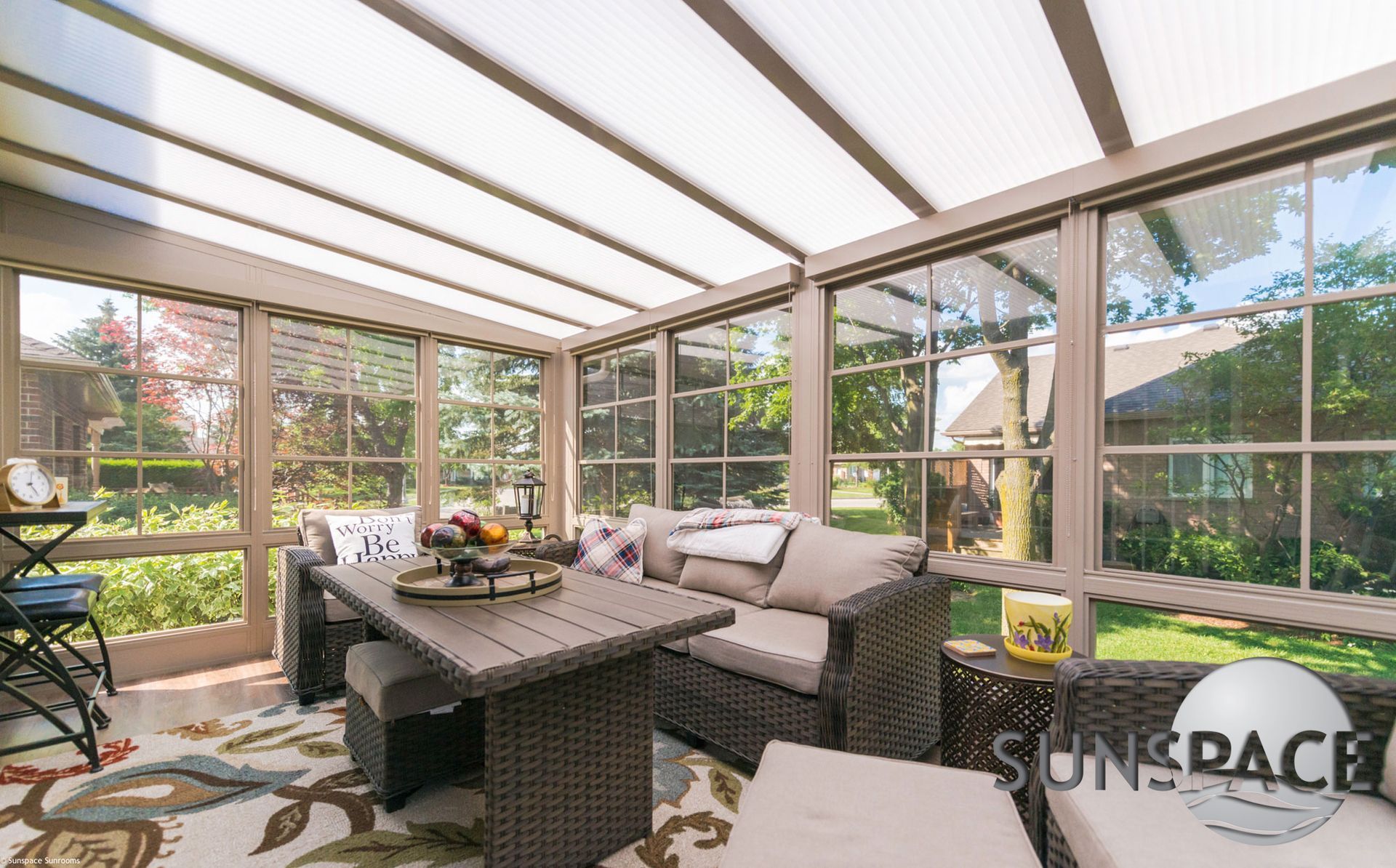 A sunroom with a table and chairs in it.