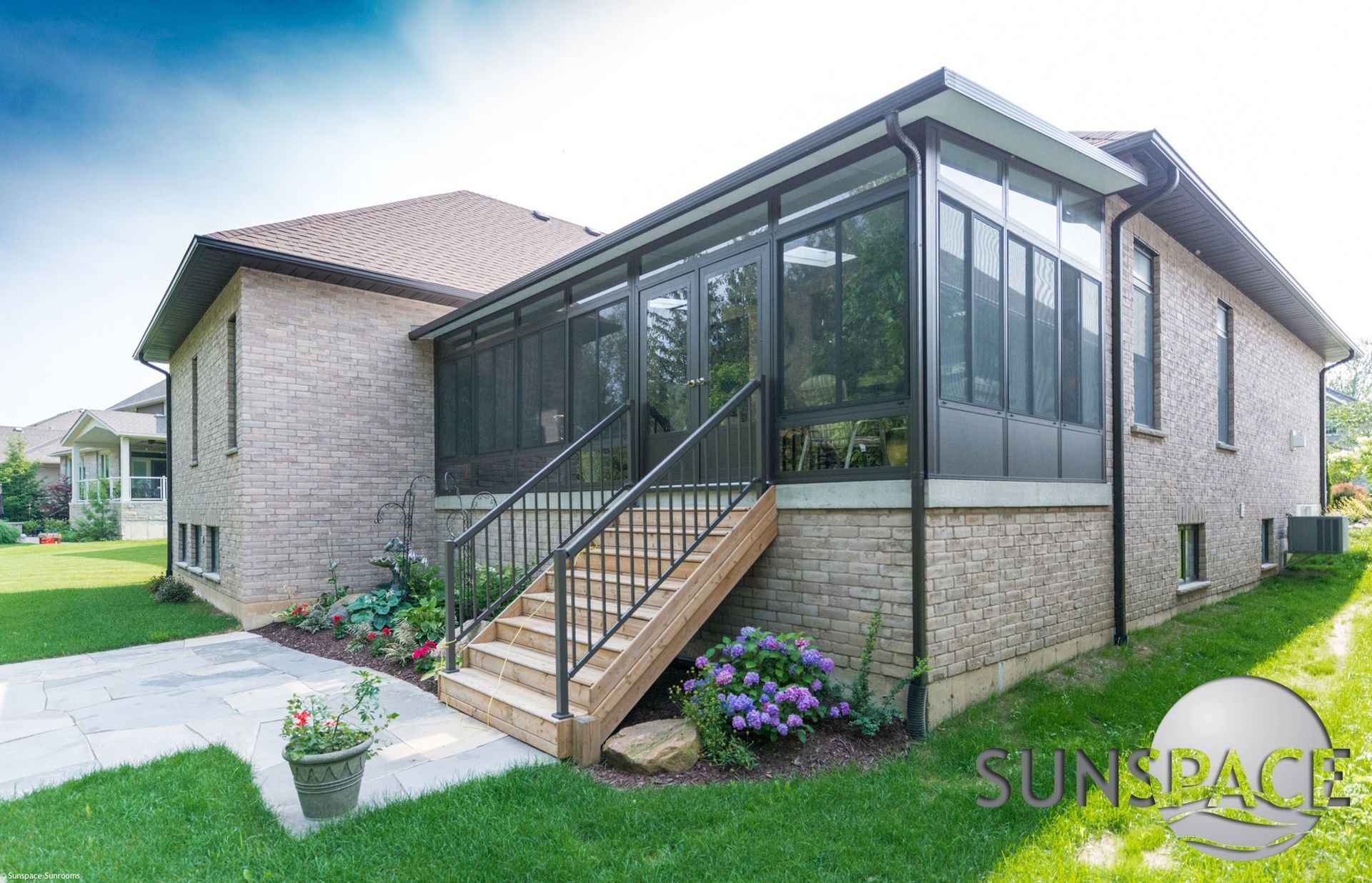 A house with a screened in porch and stairs