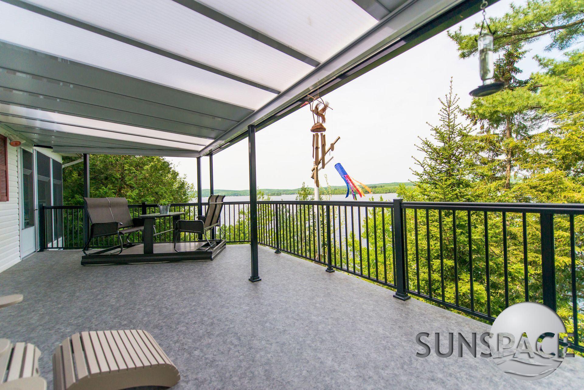 A balcony with a view of a lake and trees