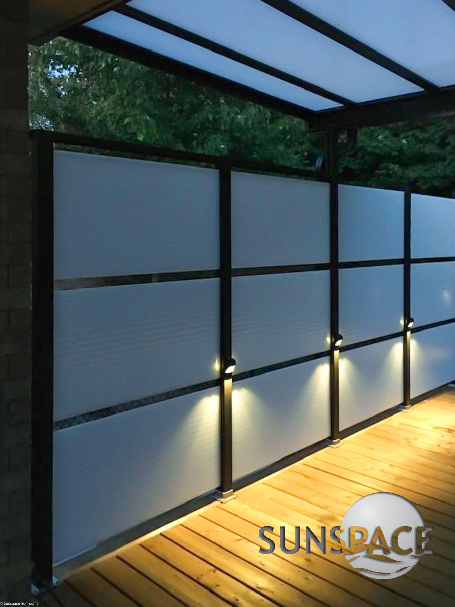 A wooden deck with a sunspace logo on the bottom