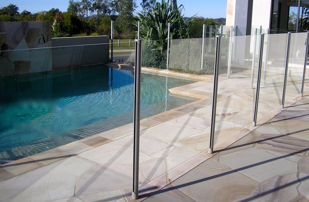 A swimming pool with a glass fence around it.