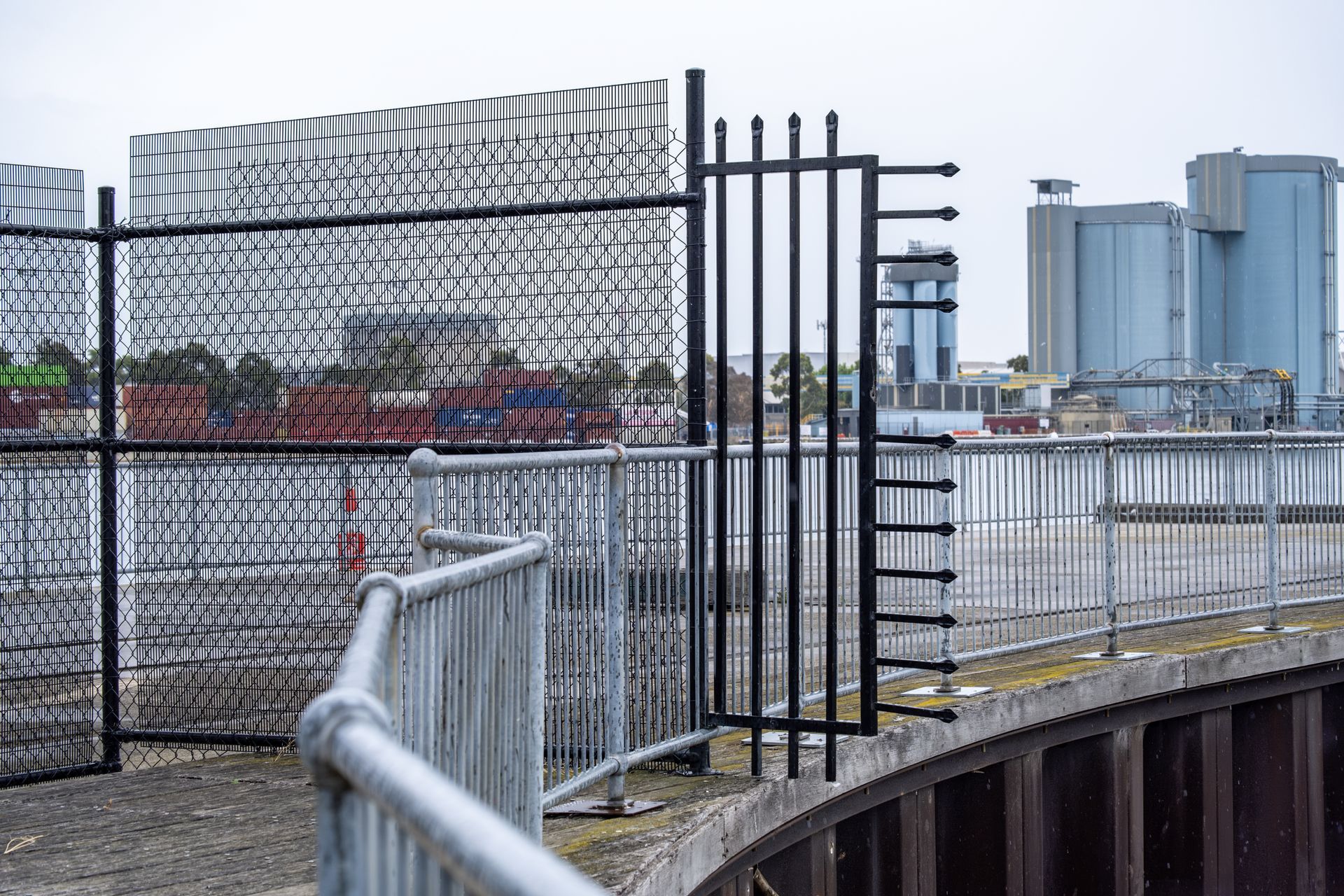 Fencing and restricted access at an industrial waterfront. 