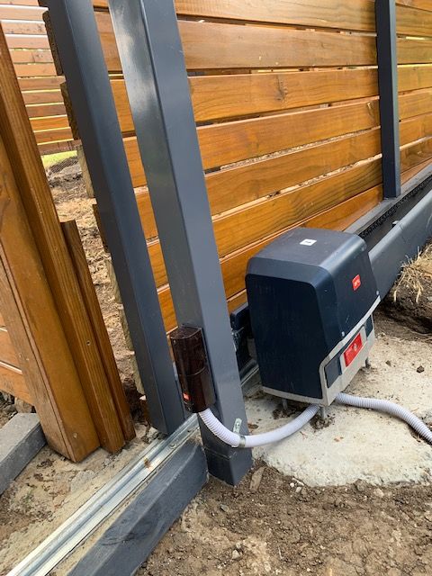 A sliding gate with a motor attached to it.