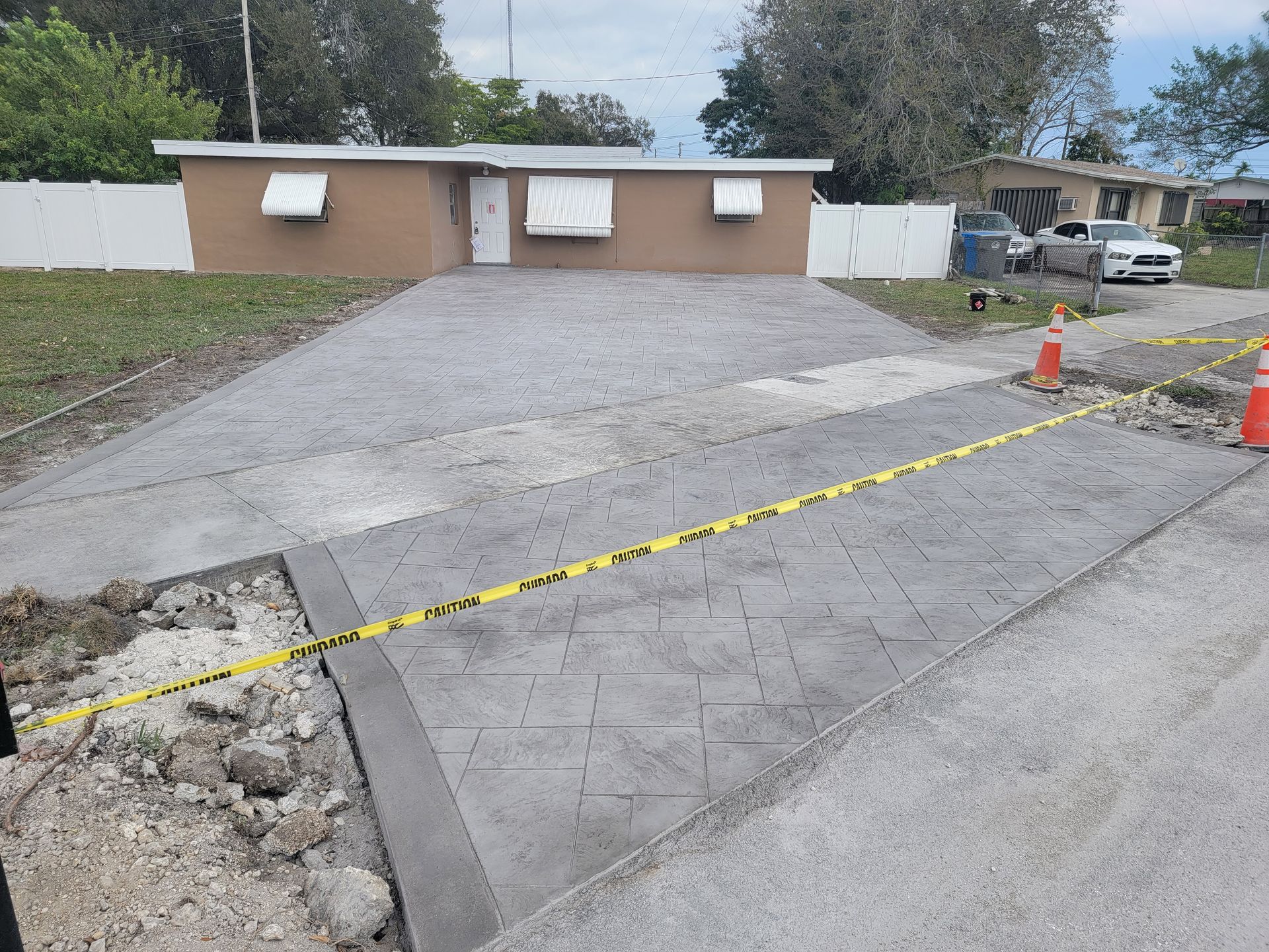 A concrete driveway is being built in front of a house.