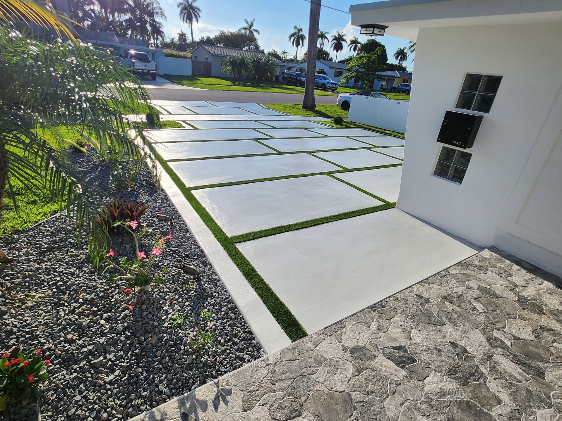 A driveway leading to a house with a lot of grass on it