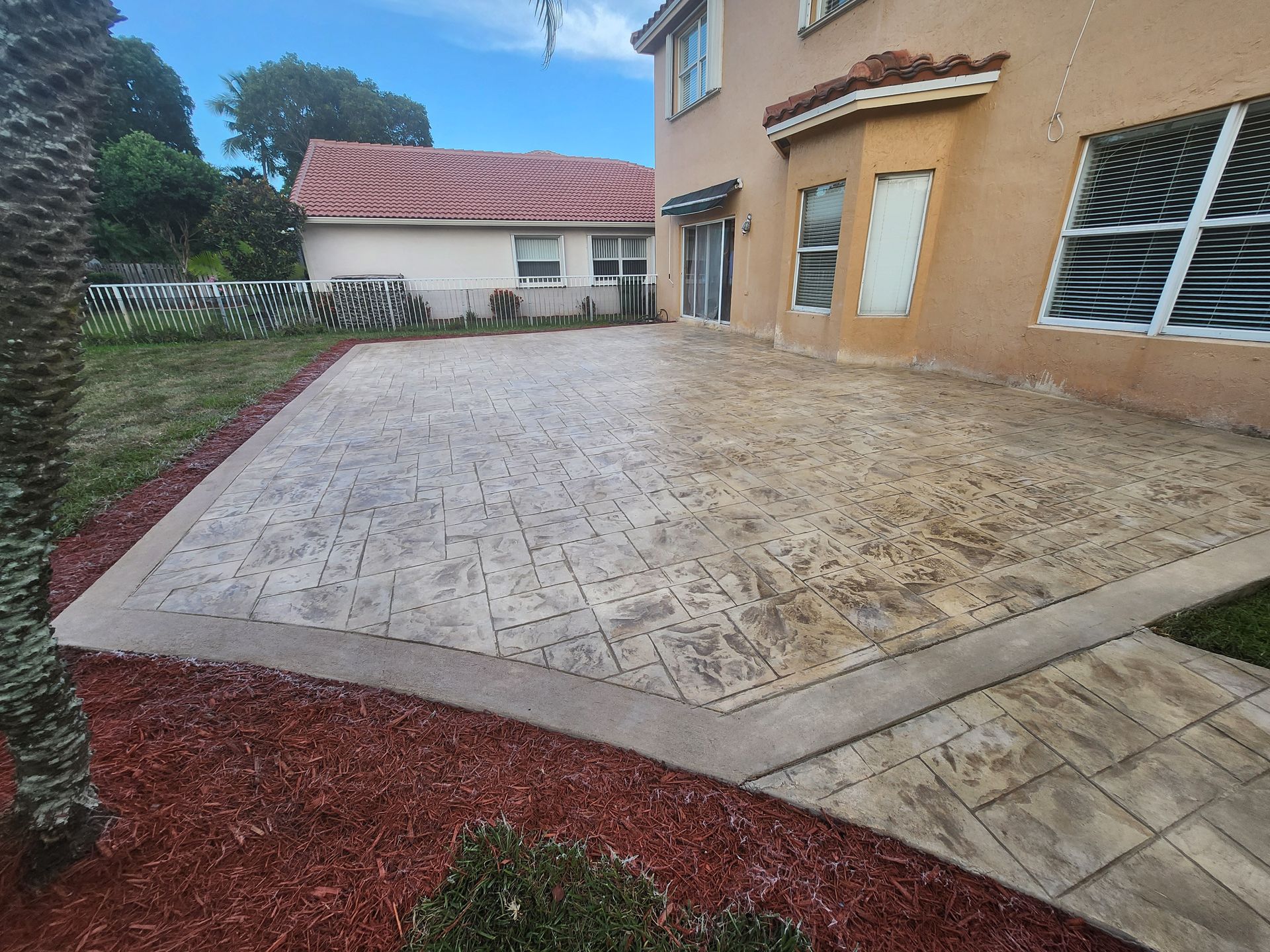 A large house with a concrete driveway in front of it.