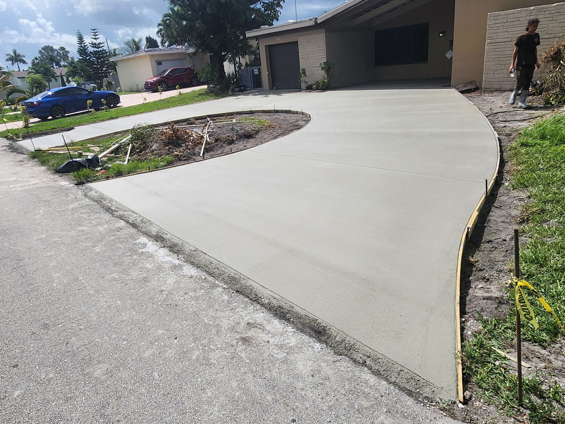 A Concrete Driveway Is Being Built in Front of A House.