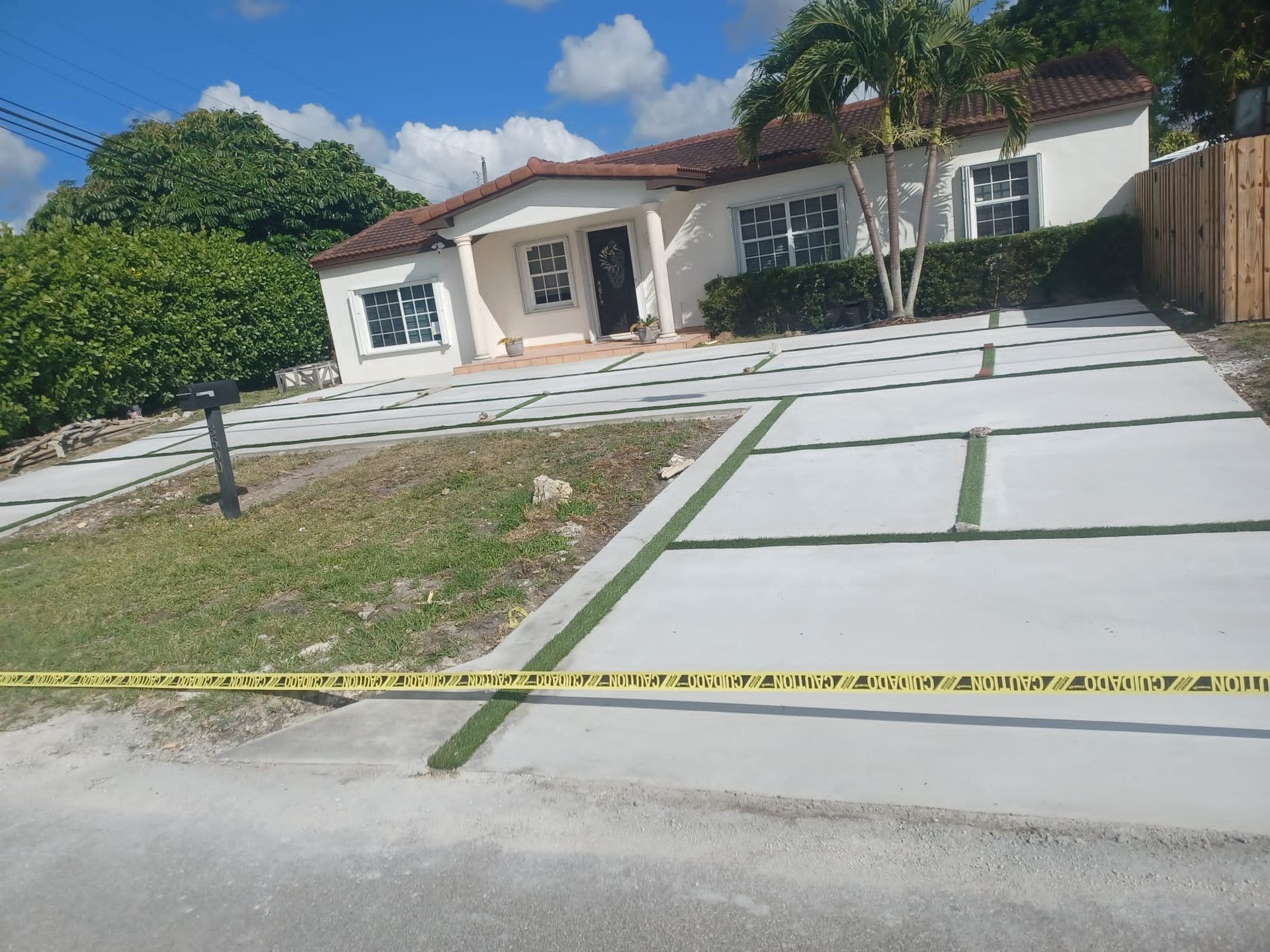 A house with a concrete driveway in front of it