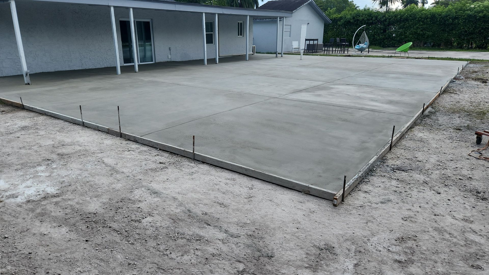 A house with an ongoing construction of a concrete driveway.