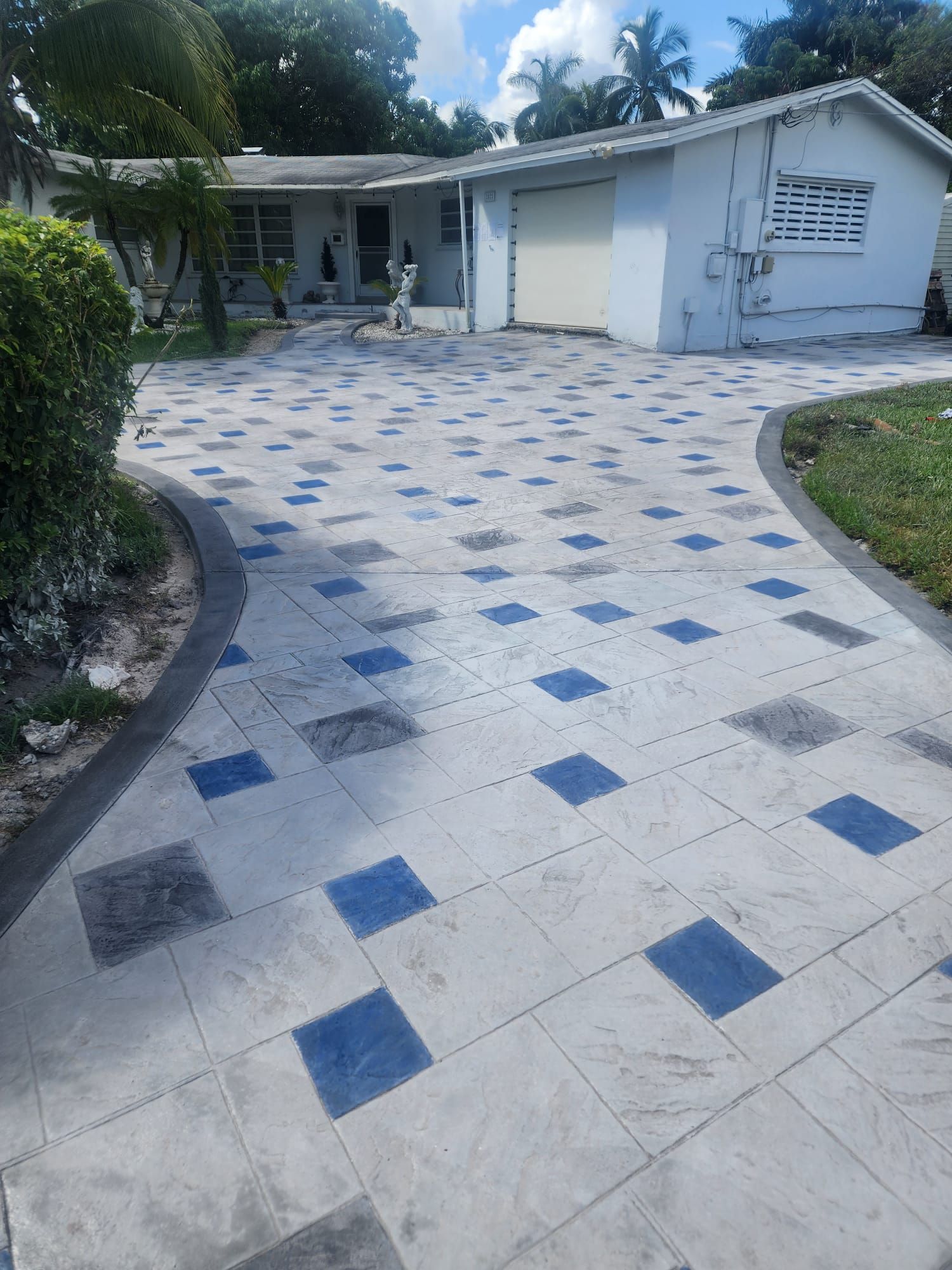 A driveway with blue squares in front of a house