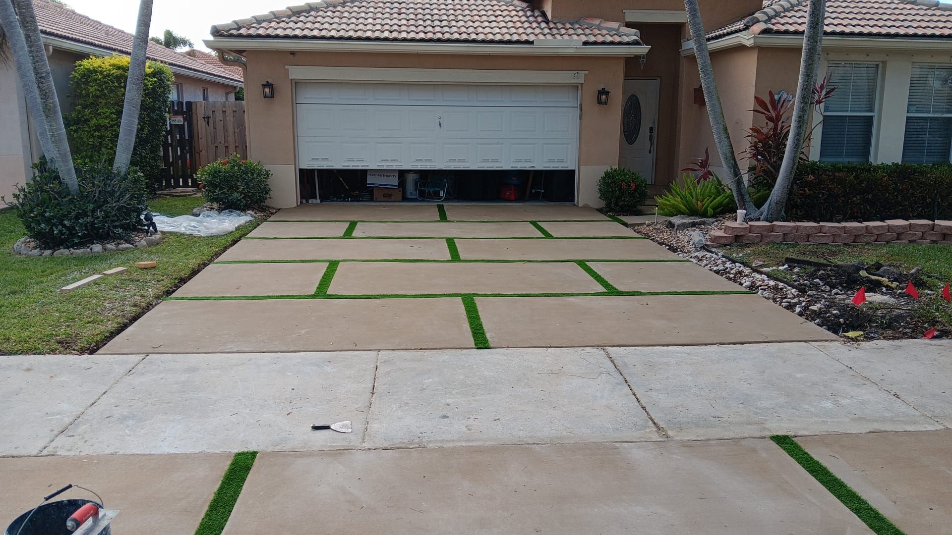 A Driveway in Front of A House with A White Garage Door