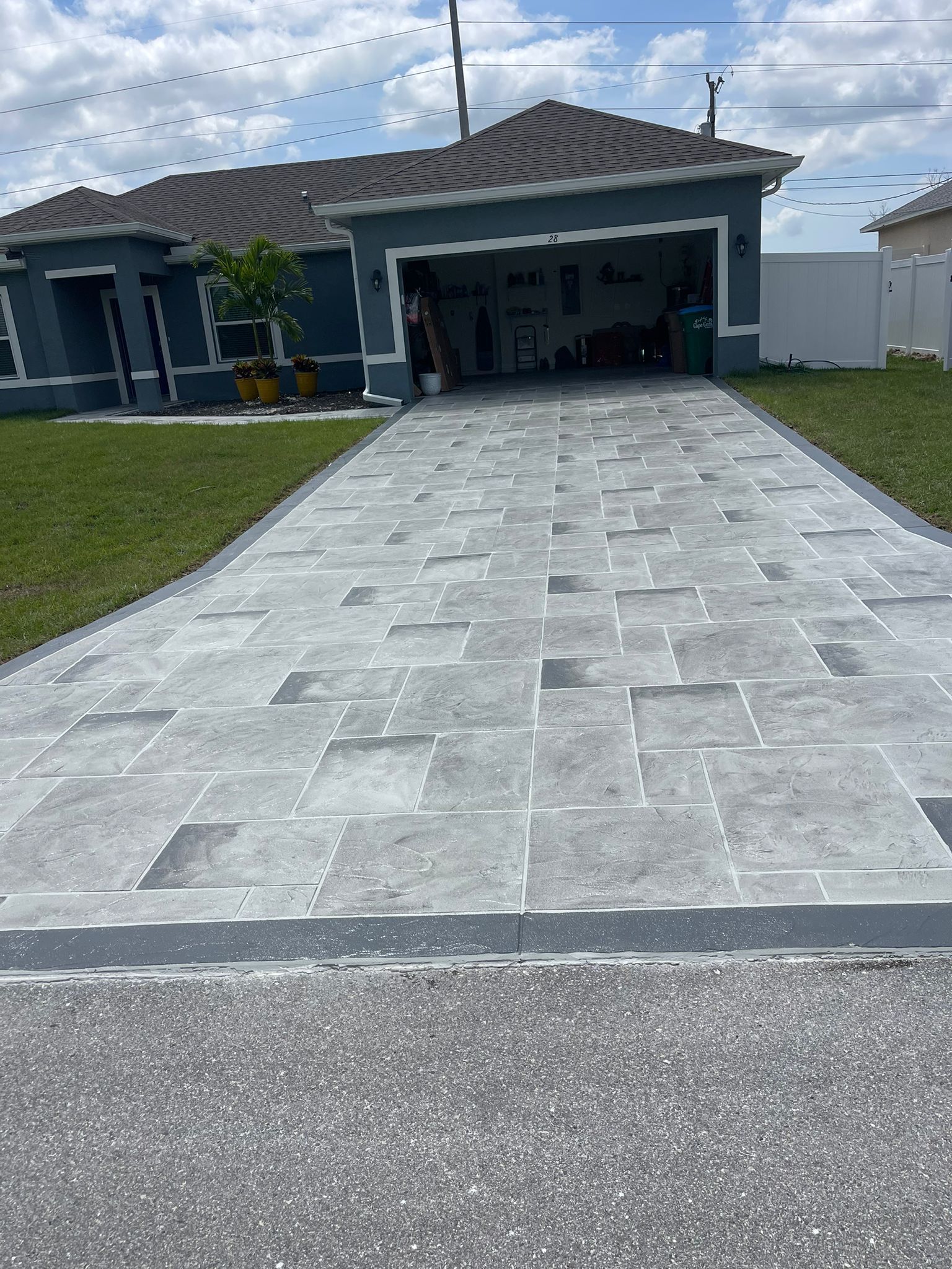 A Driveway Leading to A House with A Garage.
