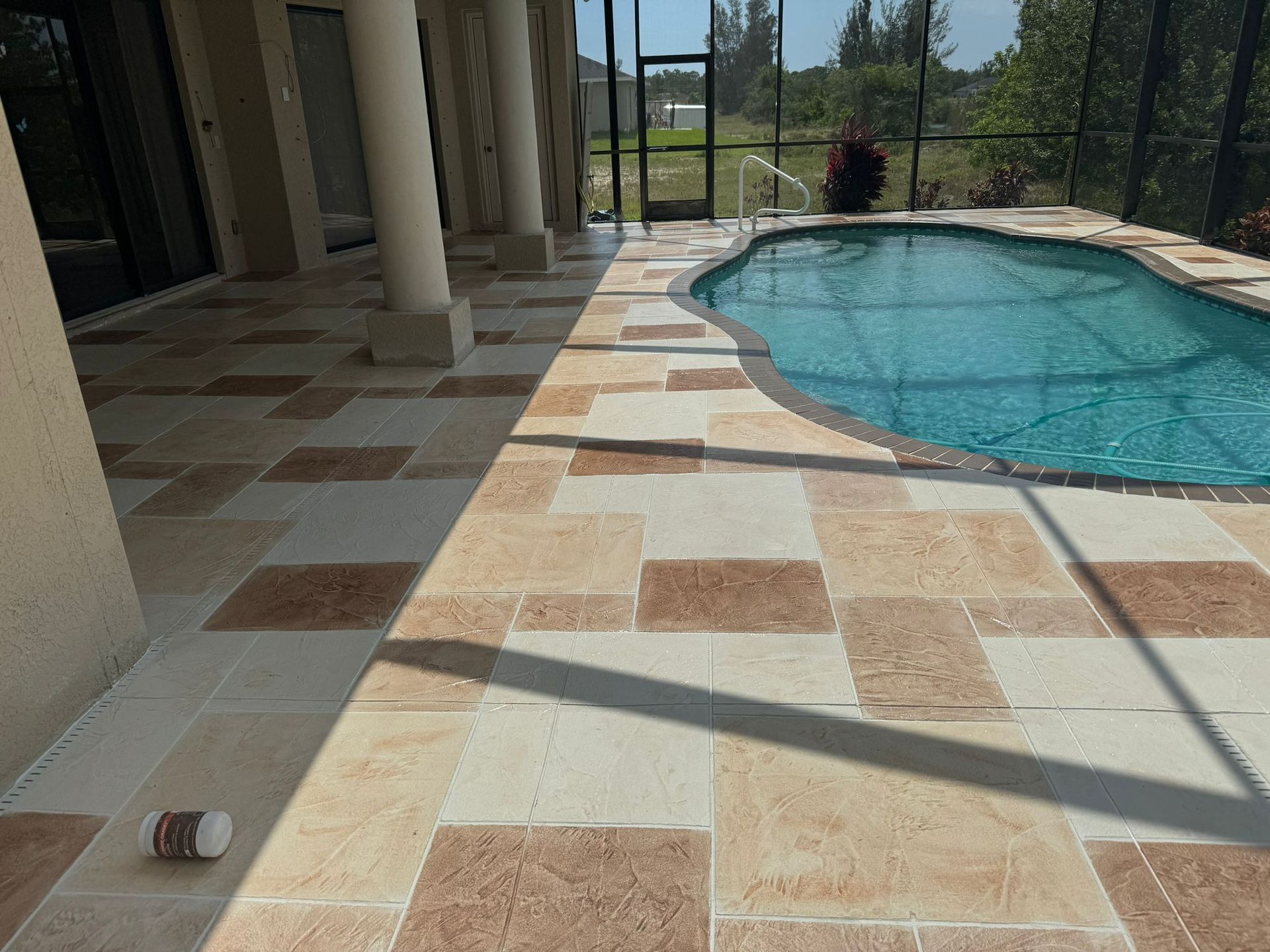 A Bottle of Pills Is on The Ground Next to A Swimming Pool