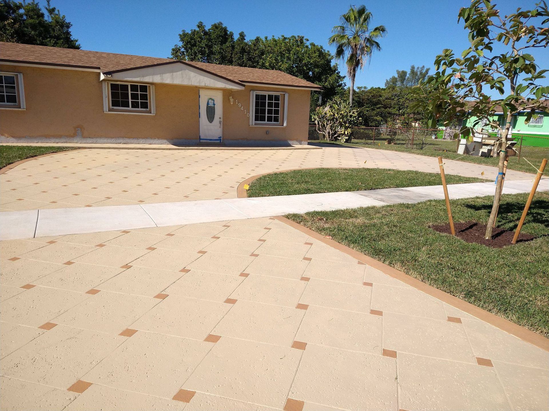 A house with a concrete driveway leading to it