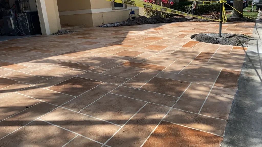 A concrete driveway is being built in front of a house.