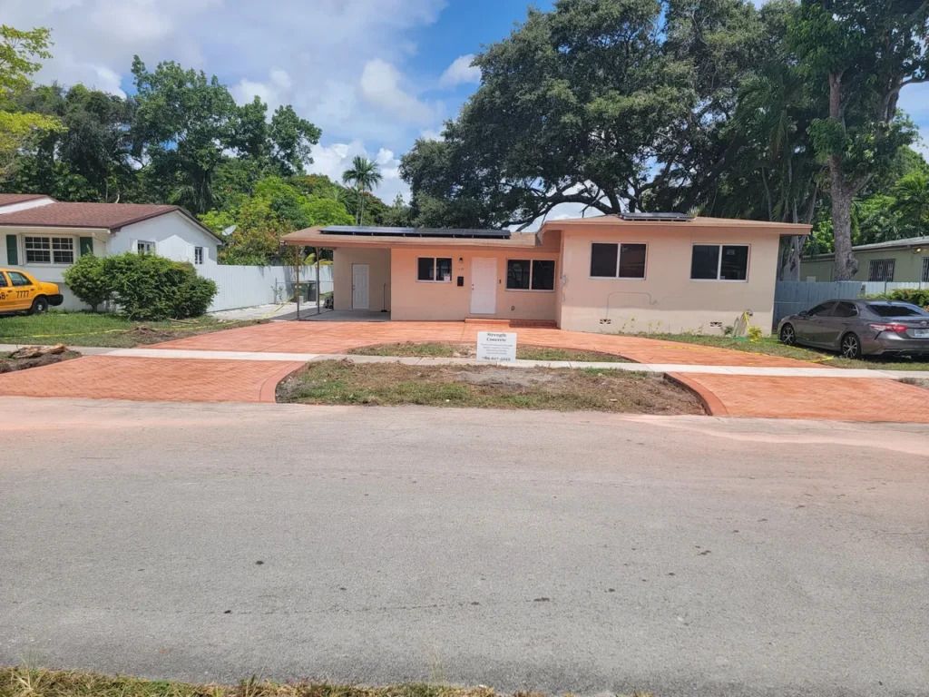 A house with a car parked in front of it