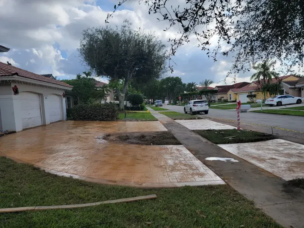 A car is parked in front of a house in a residential neighborhood.