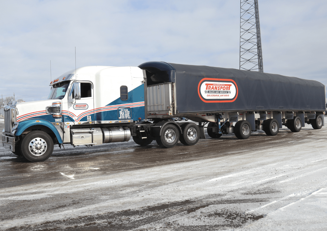 A large semi truck is parked in the snow.