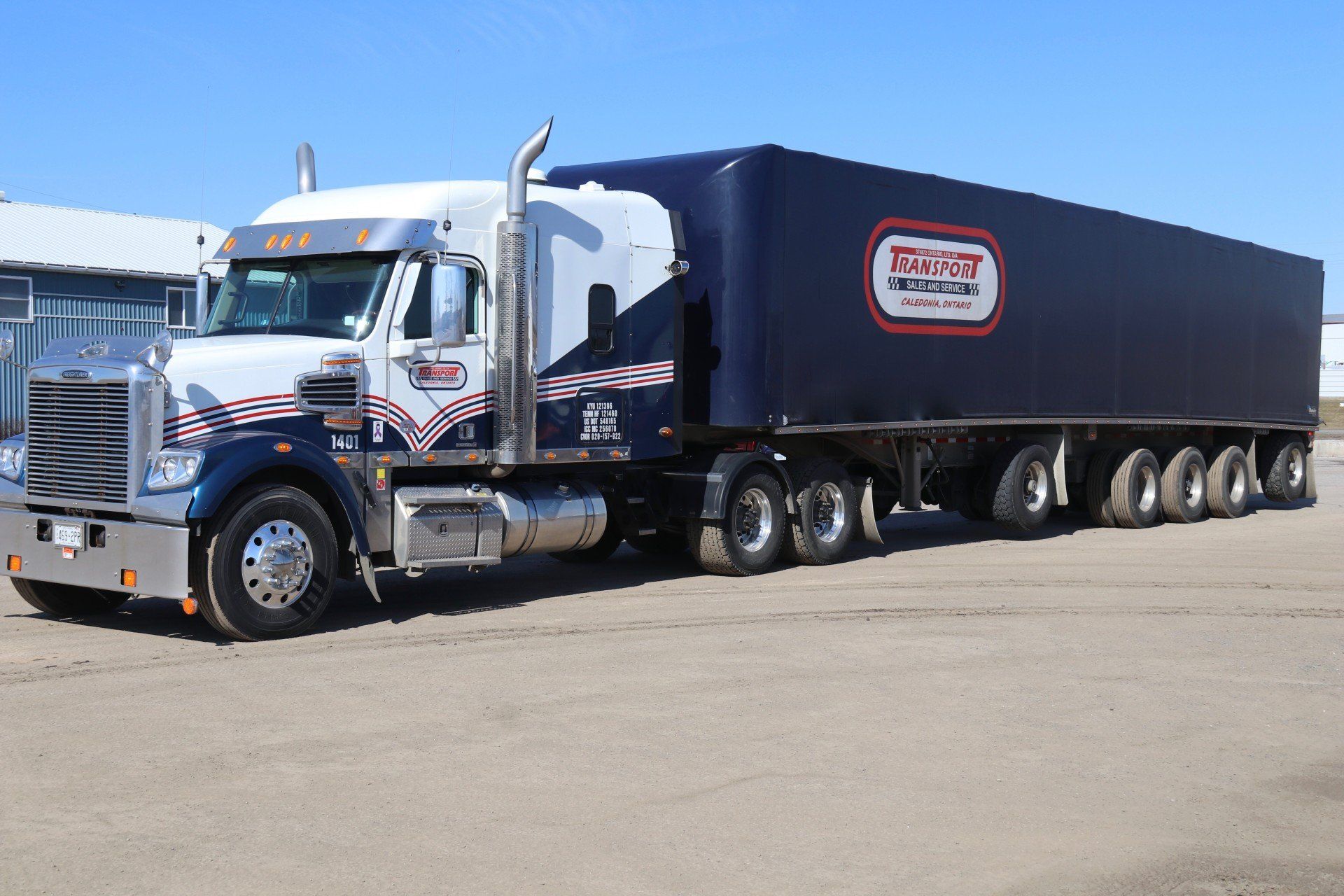 A semi truck is parked on the side of the road.