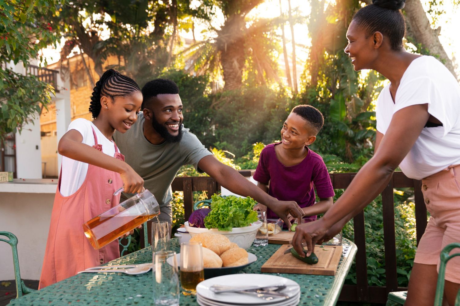 A family is sitting at a table preparing food.
