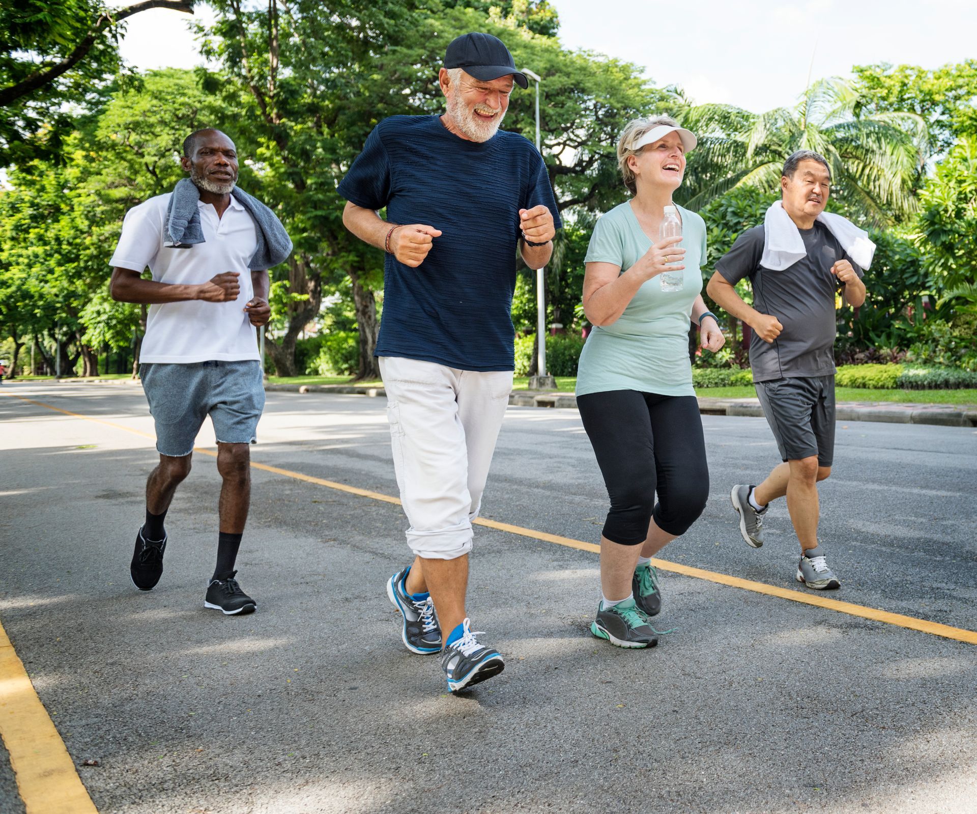 A group of older people are running down a street.
