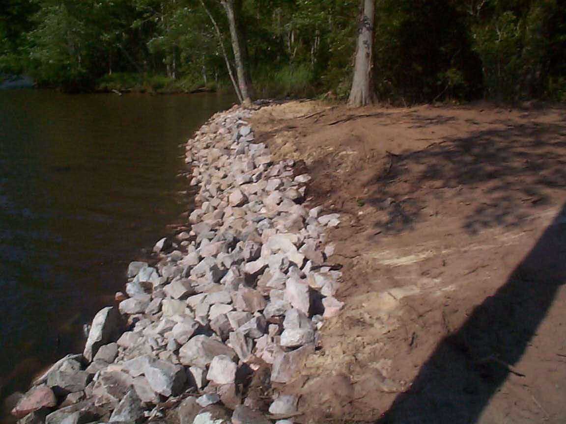 Hardscape Maintenance — Rip Rap On Lake With Trees in Shacklefords, VA