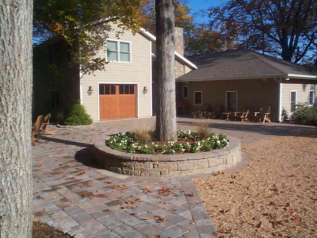 Retaining Walls Service — Hardscaping in Front of House with Circular Blocks and Tree Inside in Shacklefords, VA