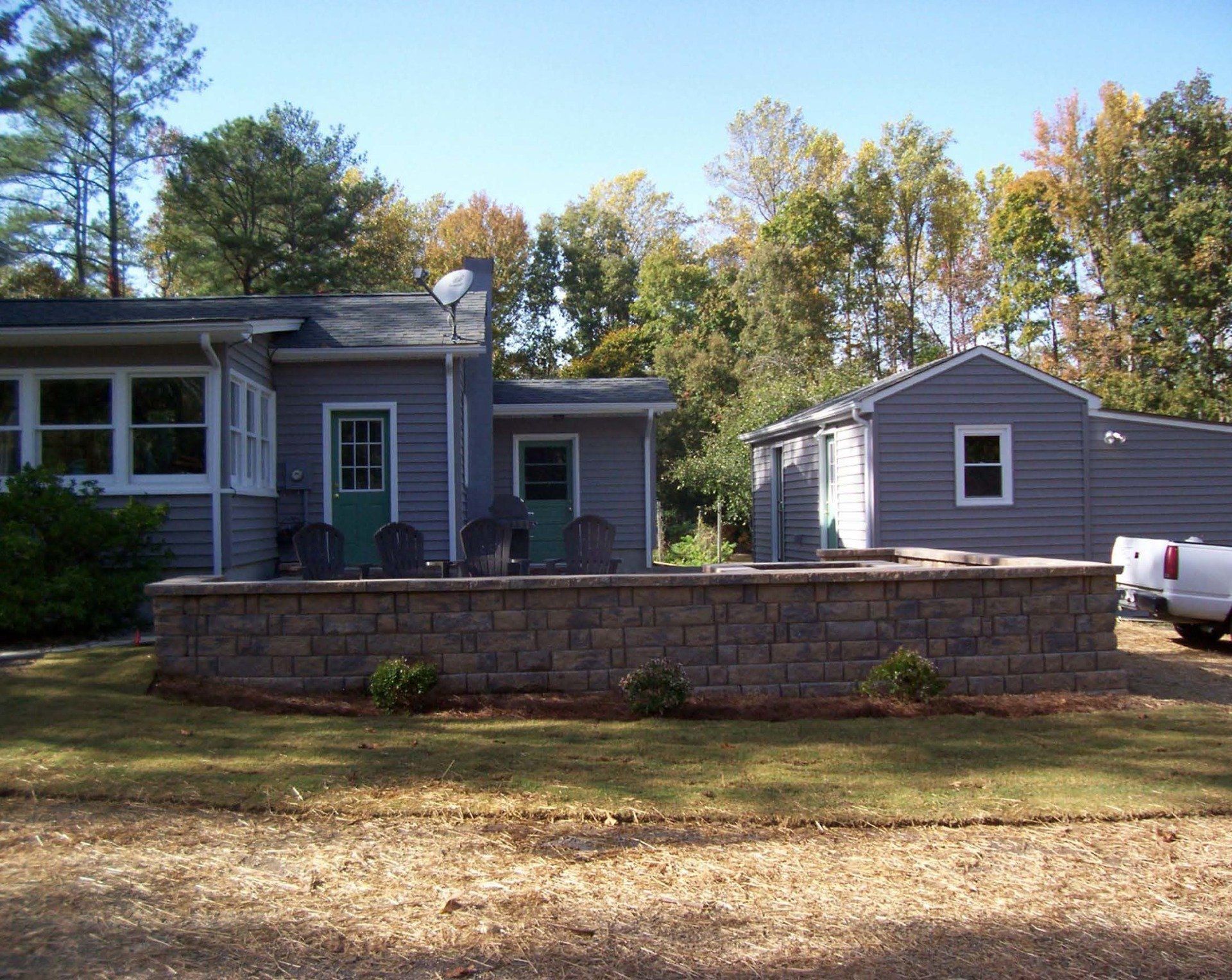 Municipal Landscaping — Retainer Wall In Middle Of Two Houses in Shacklefords, VA