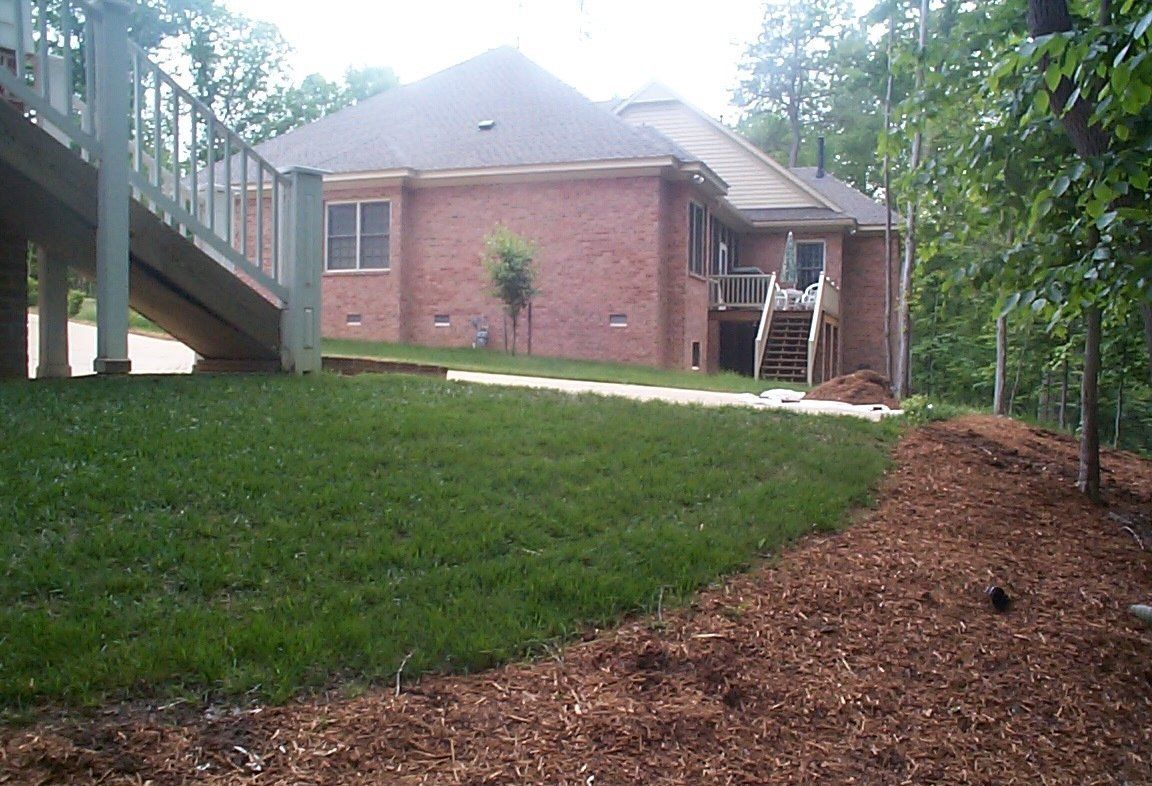 Decks Installation — Brick Made House With Grass Field in Shacklefords, VA