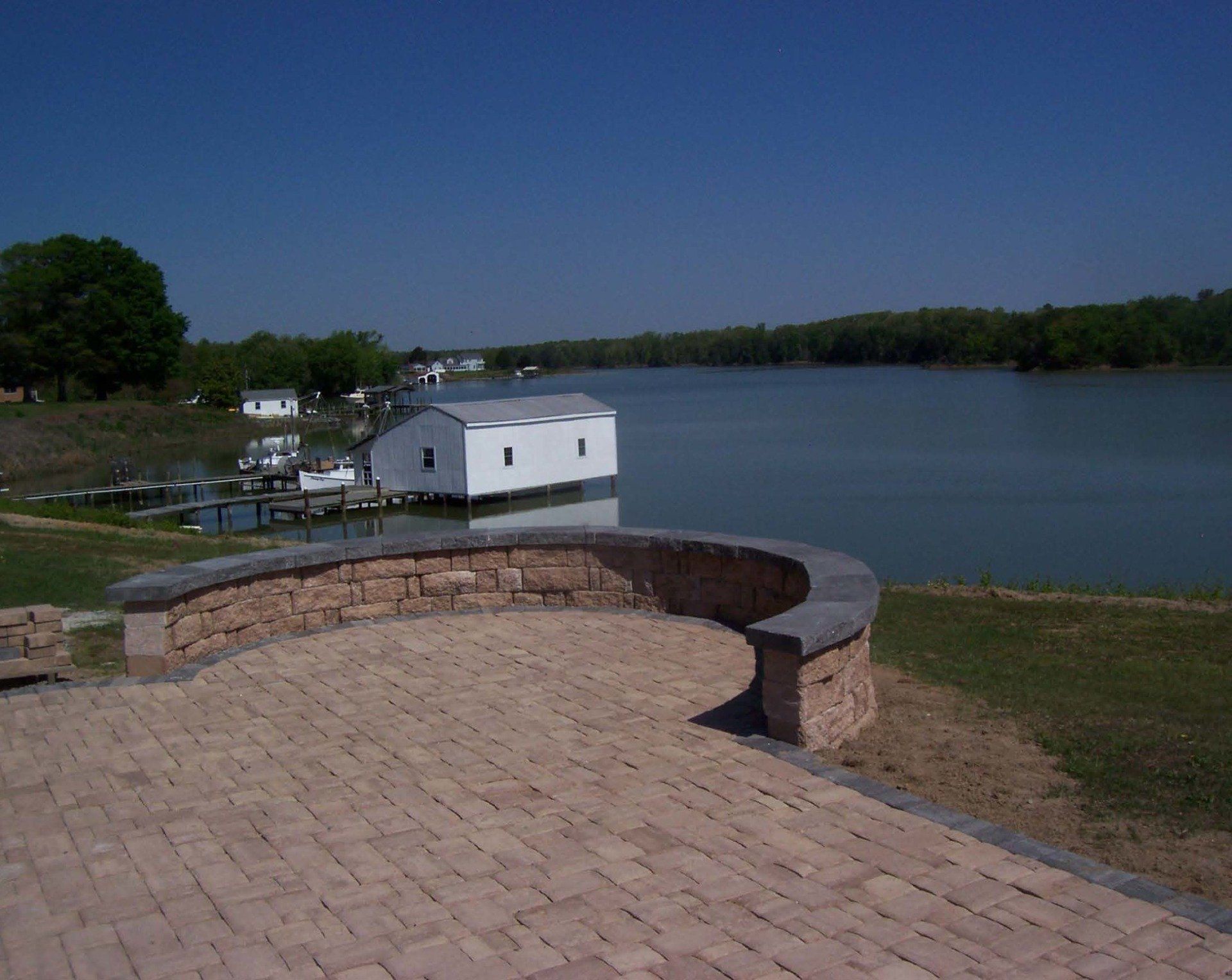 Municipal Landscaping Maintenance — Curved Retainer Wall With Lake in Shacklefords, VA