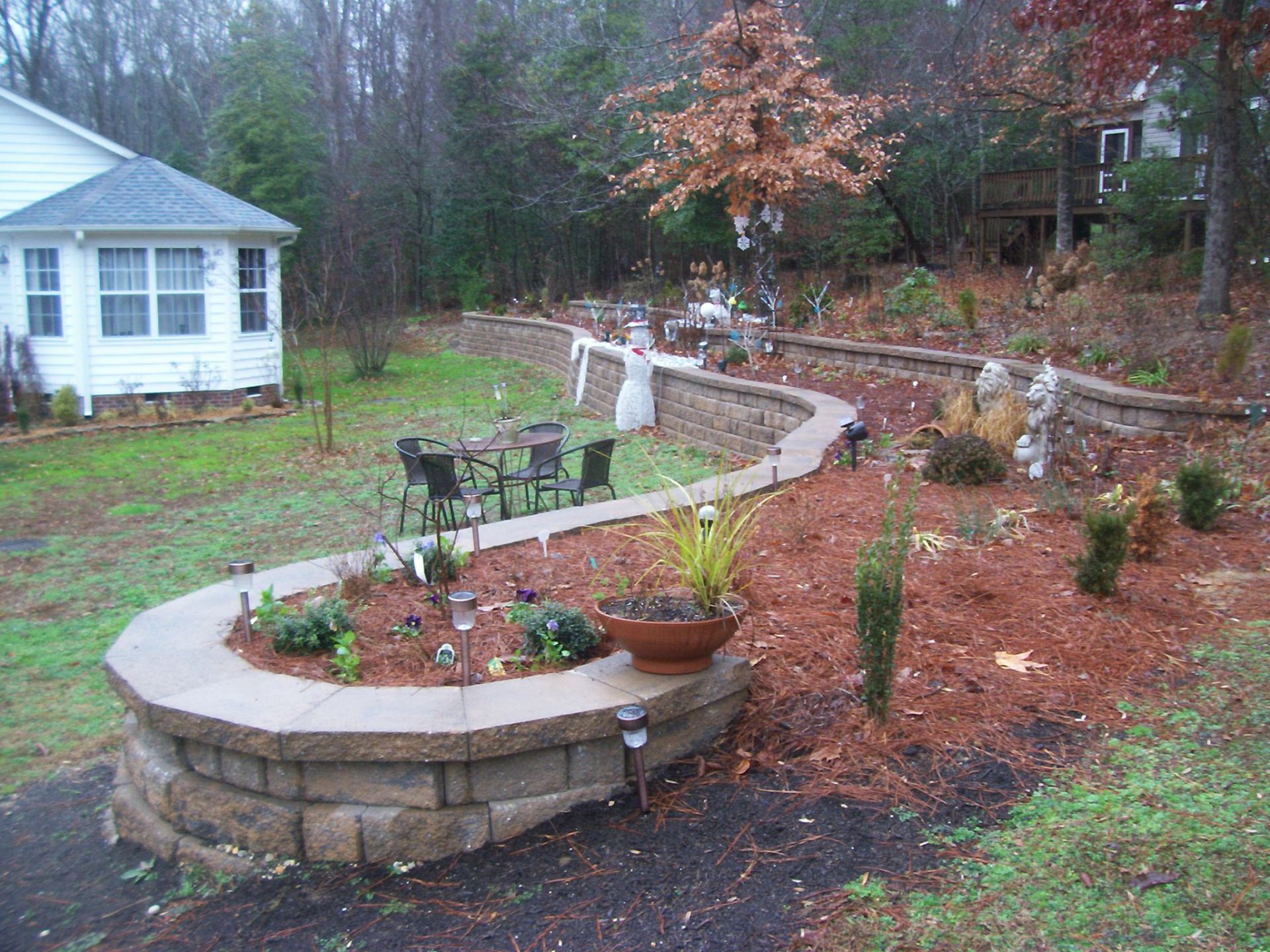 Municipal Landscape Maintenance Service — Retainer Wall With Pots And White House in Shacklefords, VA
