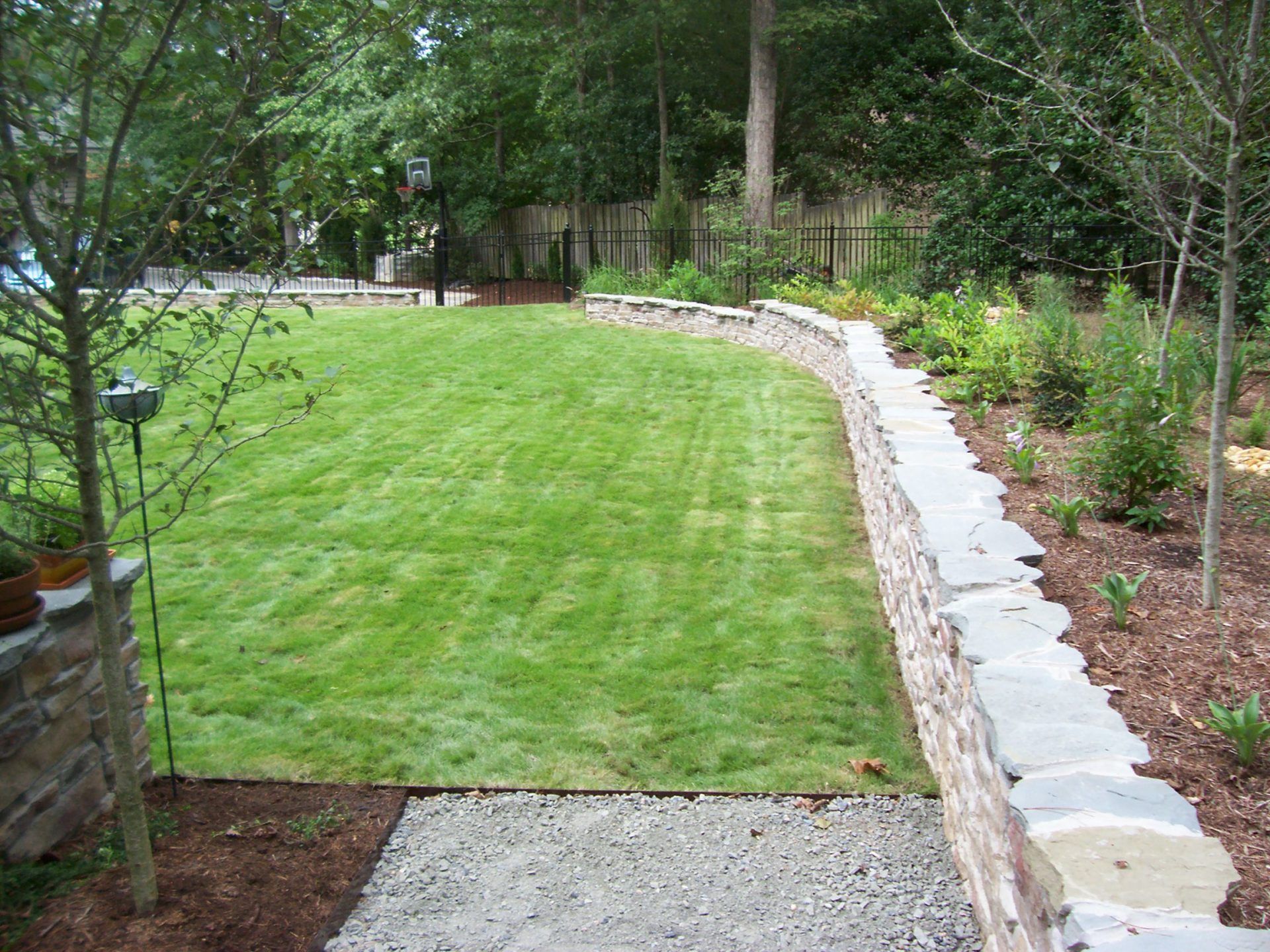 Patios Repair — Grass Field With Retainer Wall in Shacklefords, VA