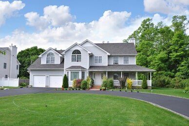 Suburban Home with circular blacktop driveway - Paving Services In Fairfield, Maine
