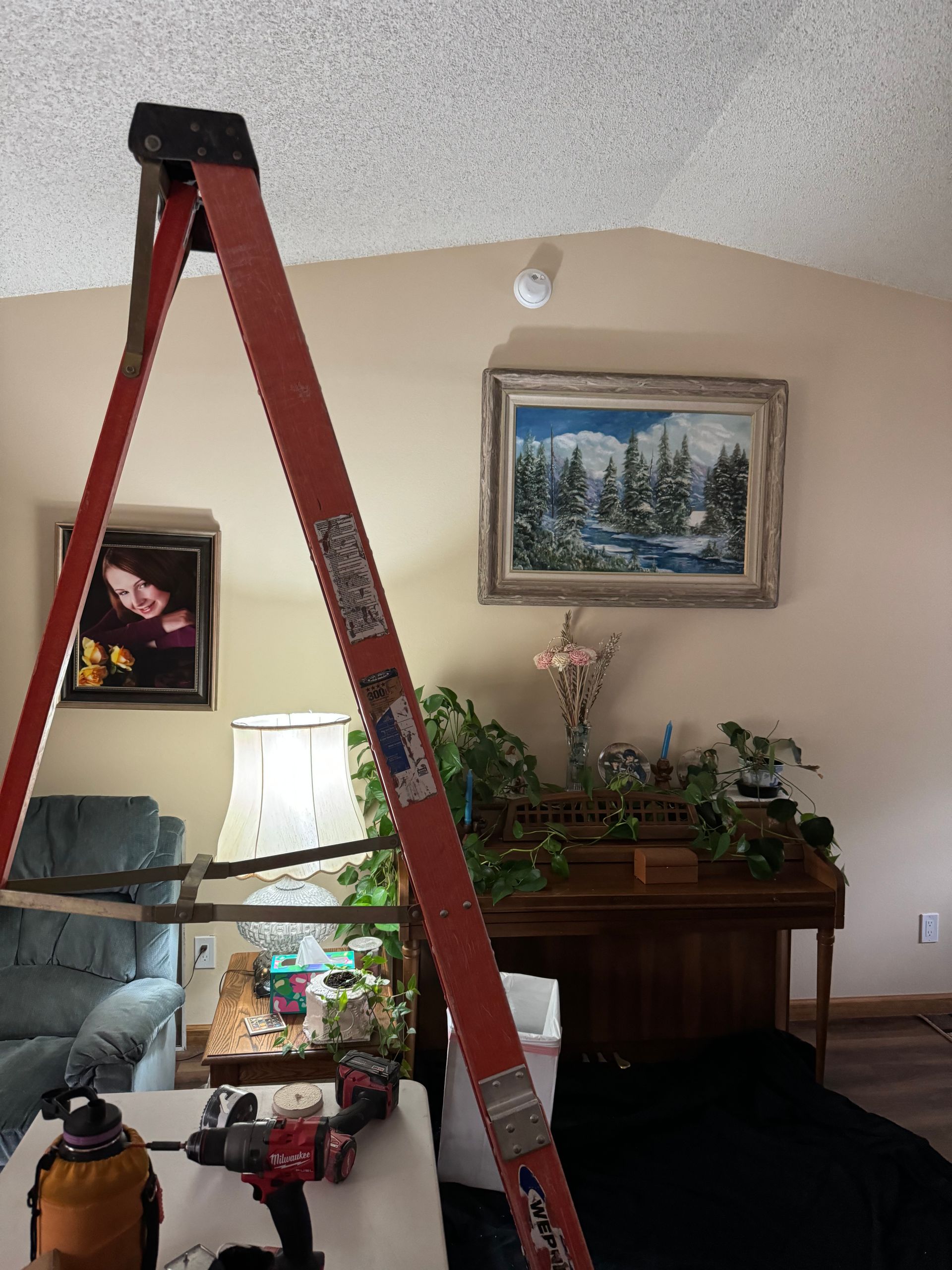 Skilled electrician in work attire, installing wiring in a residential electrical system.