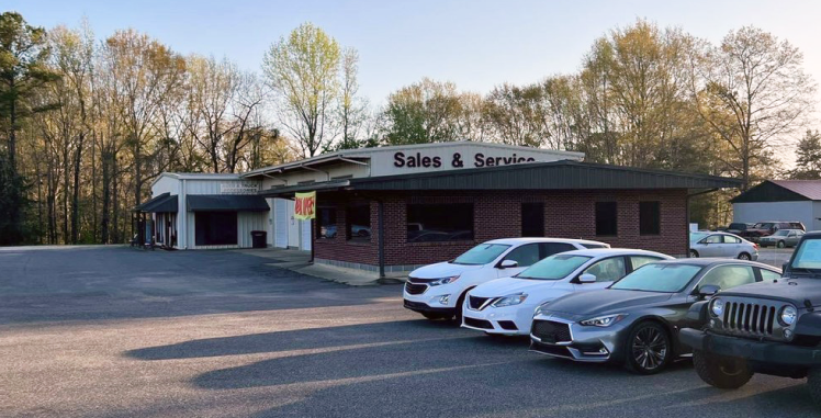 Cars parked in front of a brick building with 