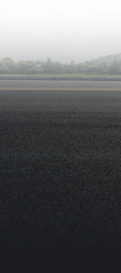 Black asphalt landscape with blurred mountains and fog in the background. | Bama Direct Automotive Llc