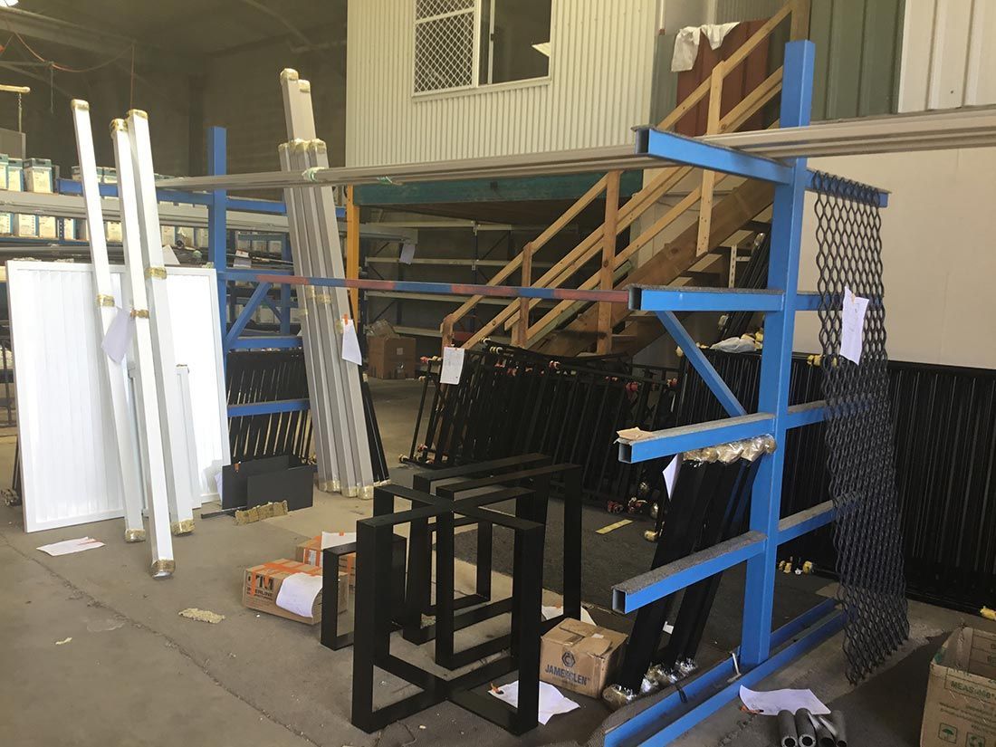 A Warehouse Filled With Lots of Pieces of Metal and Stairs — Hastings Valley Powdercoaters in Laurieton, NSW