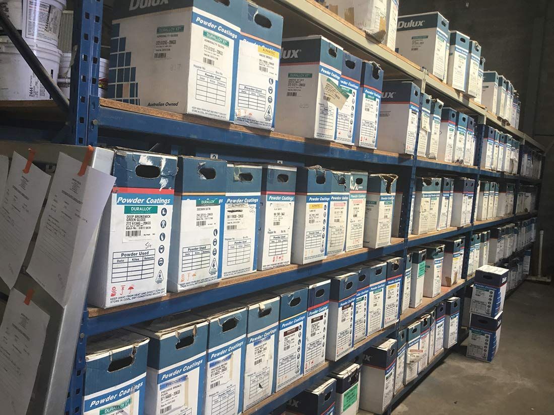 A Warehouse Filled With Lots of Blue and White Boxes — Hastings Valley Powdercoaters in Nambucca Heads, NSW