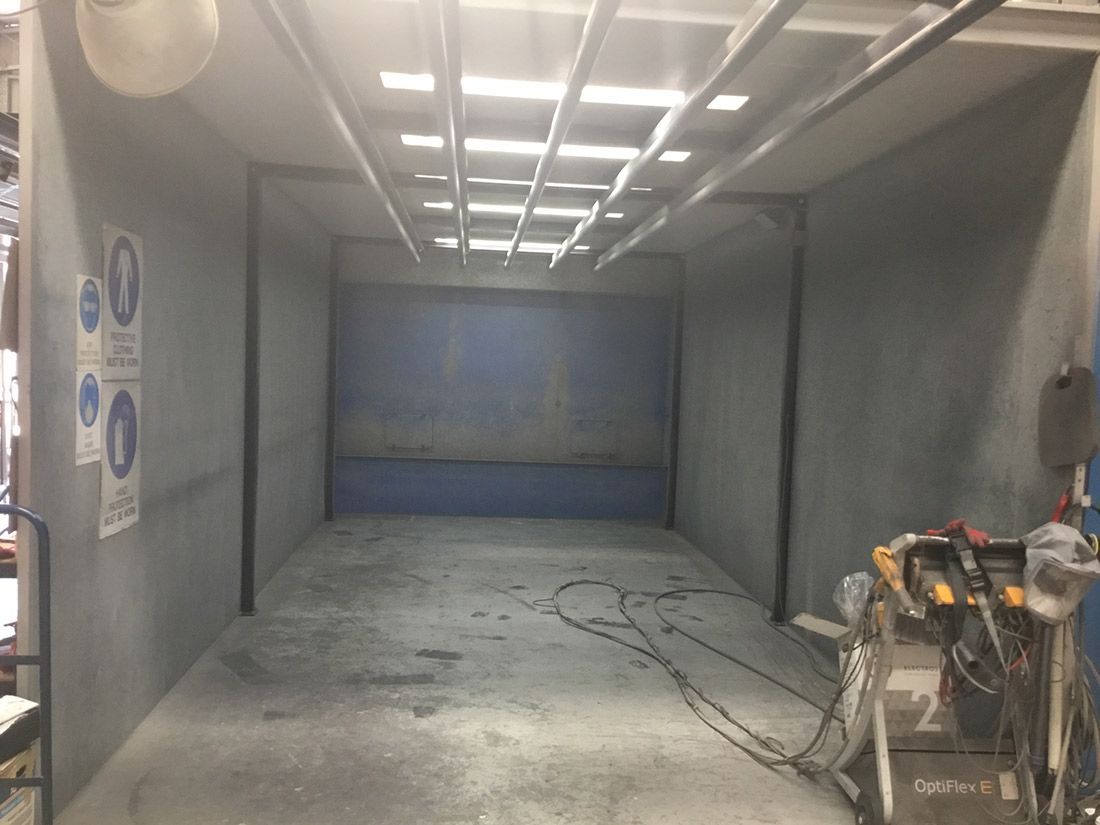 A Large Empty Room With a Blue Wall and a Ceiling — Hastings Valley Powdercoaters in Forster, NSW