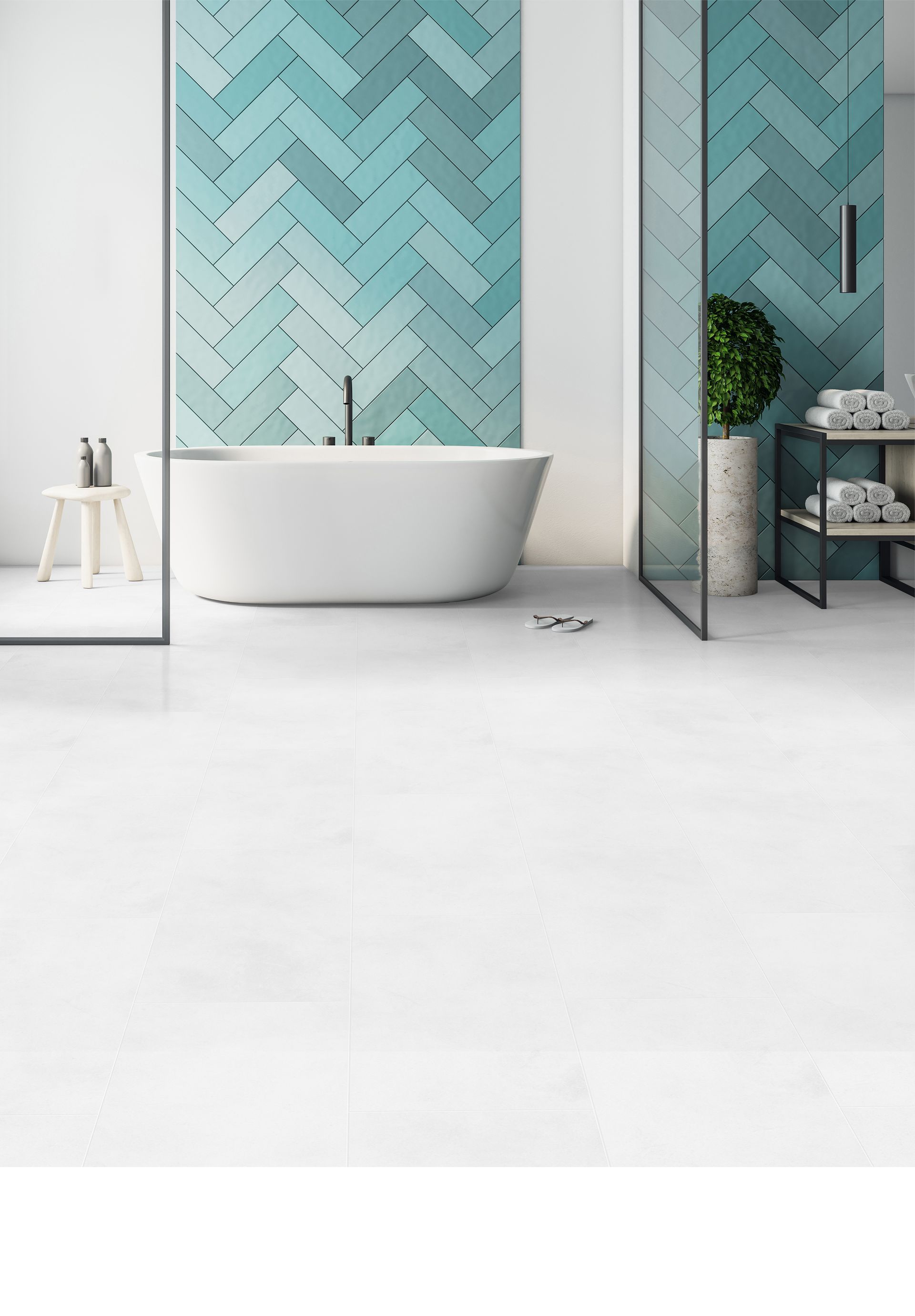 Modern bathroom with a freestanding tub, teal geometric tile wall, and white floor tiles