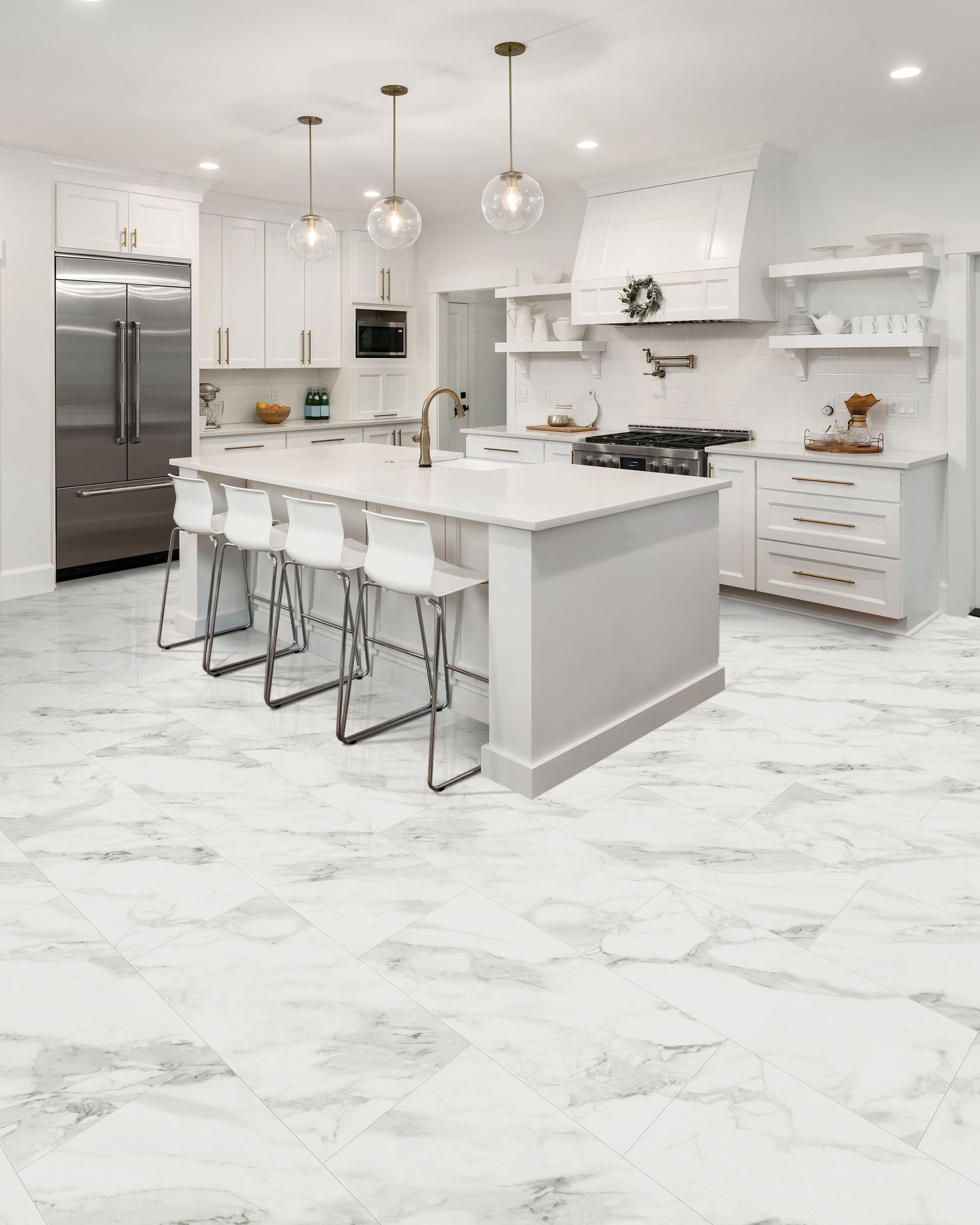 Bright white modern kitchen with marble floors, island seating, stainless steel fridge, and pendant lights