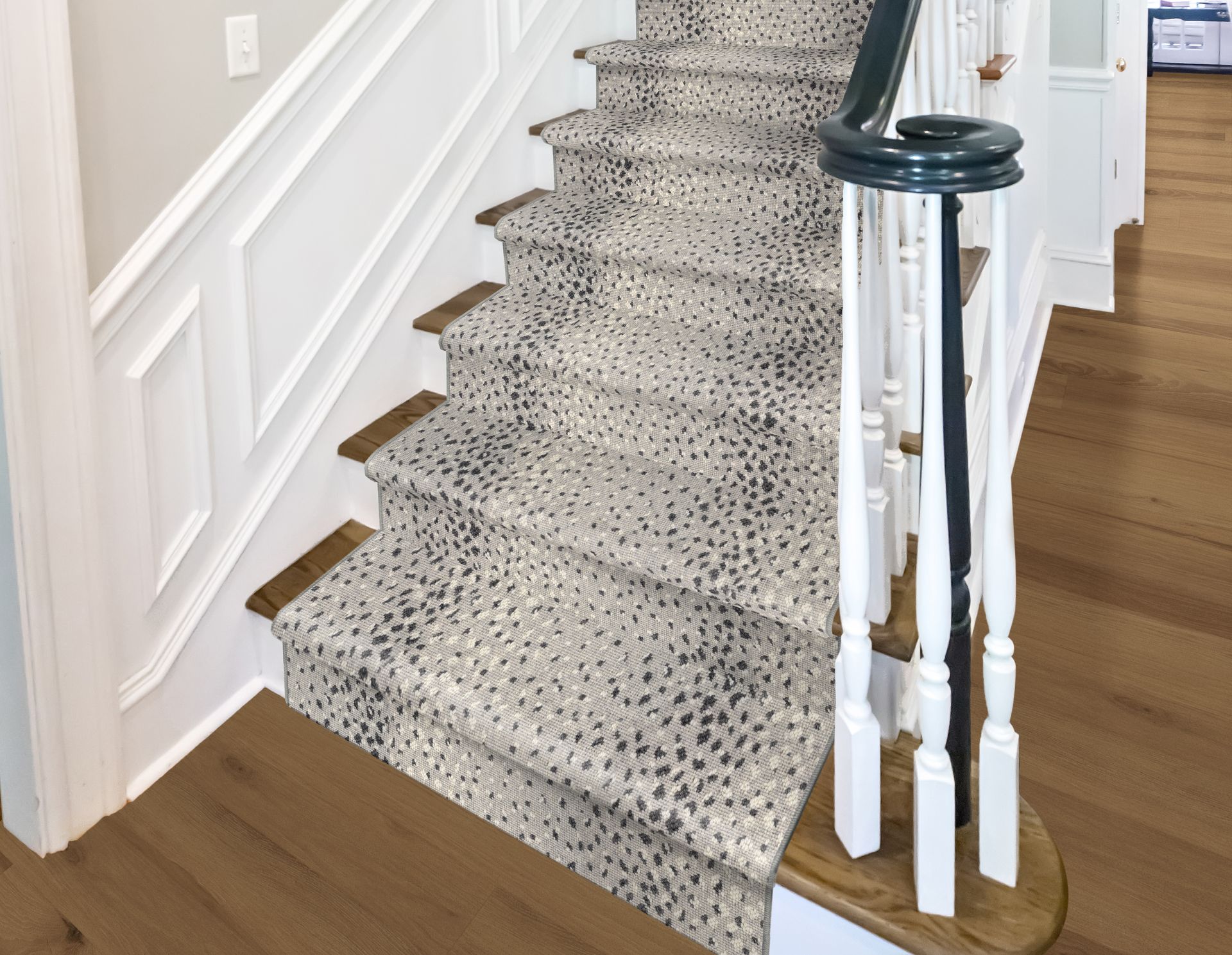 Staircase with animal print carpet runner and white and dark wood trim.