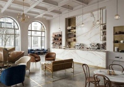 Elegant cafe interior with marble counter, arched windows, and seating.