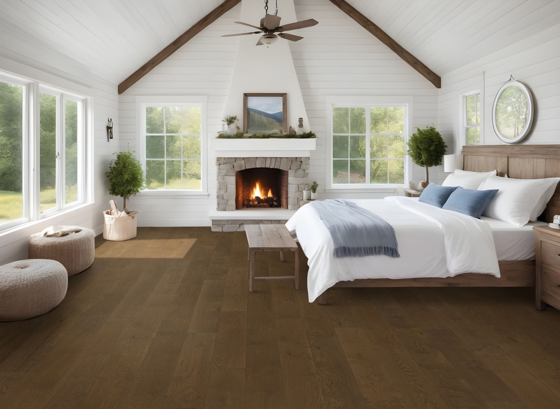 Cozy bedroom with fireplace, windows, hardwood floor, and bed with blue accents.
