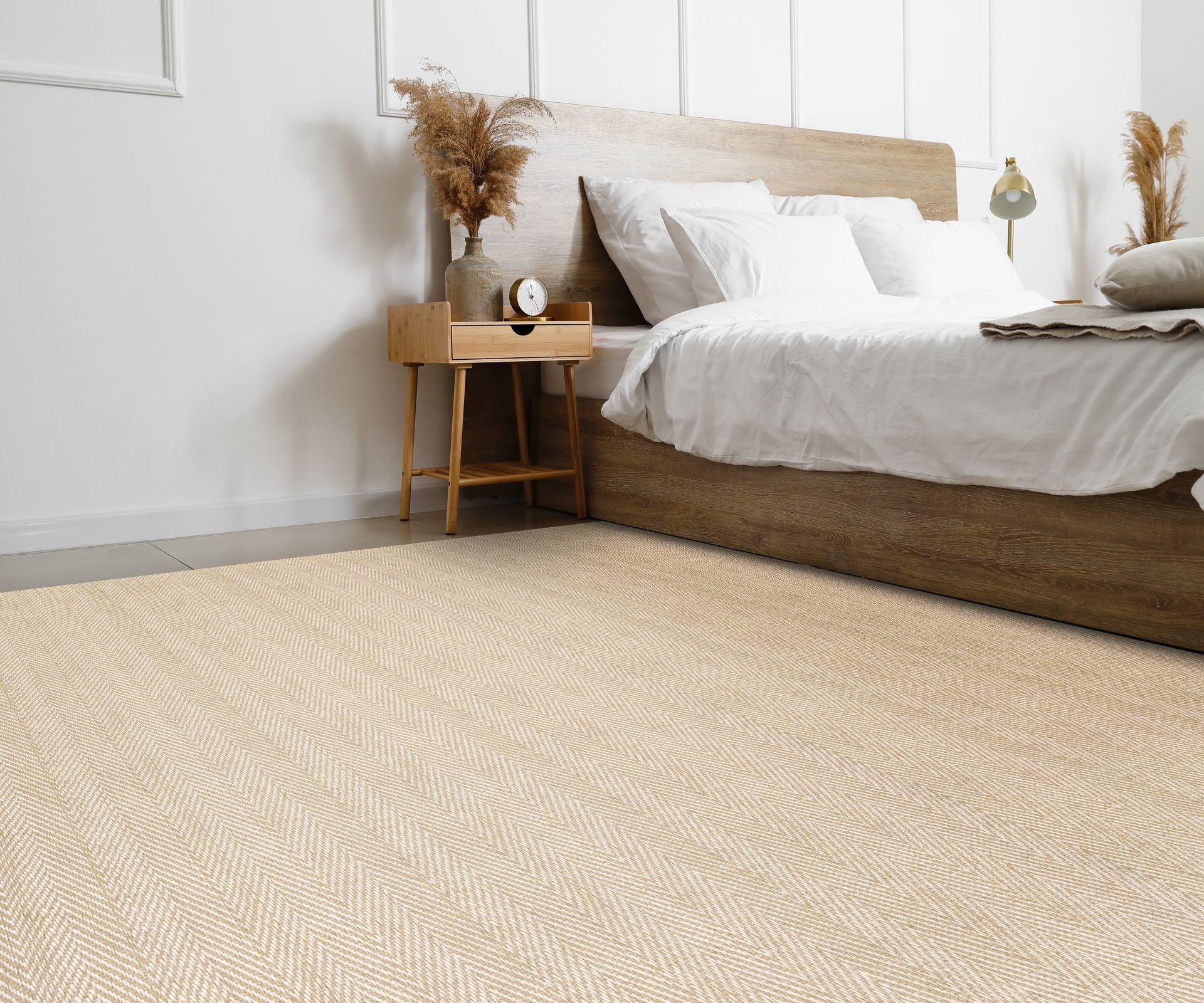Beige textured rug in a bedroom with a wooden bed and nightstand.