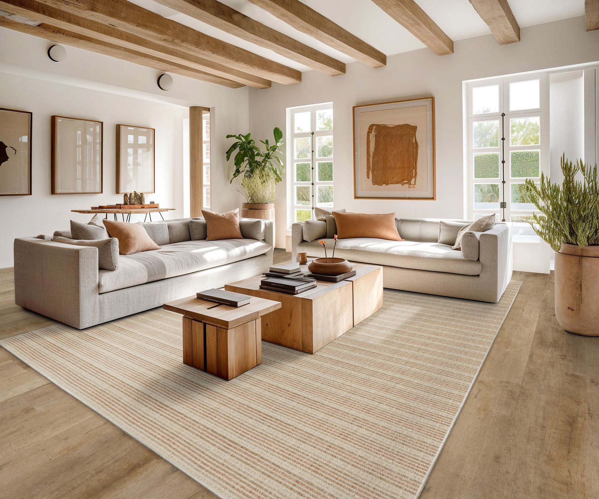 Living room with neutral tones, two sofas, wooden beams, a rug, and artwork.