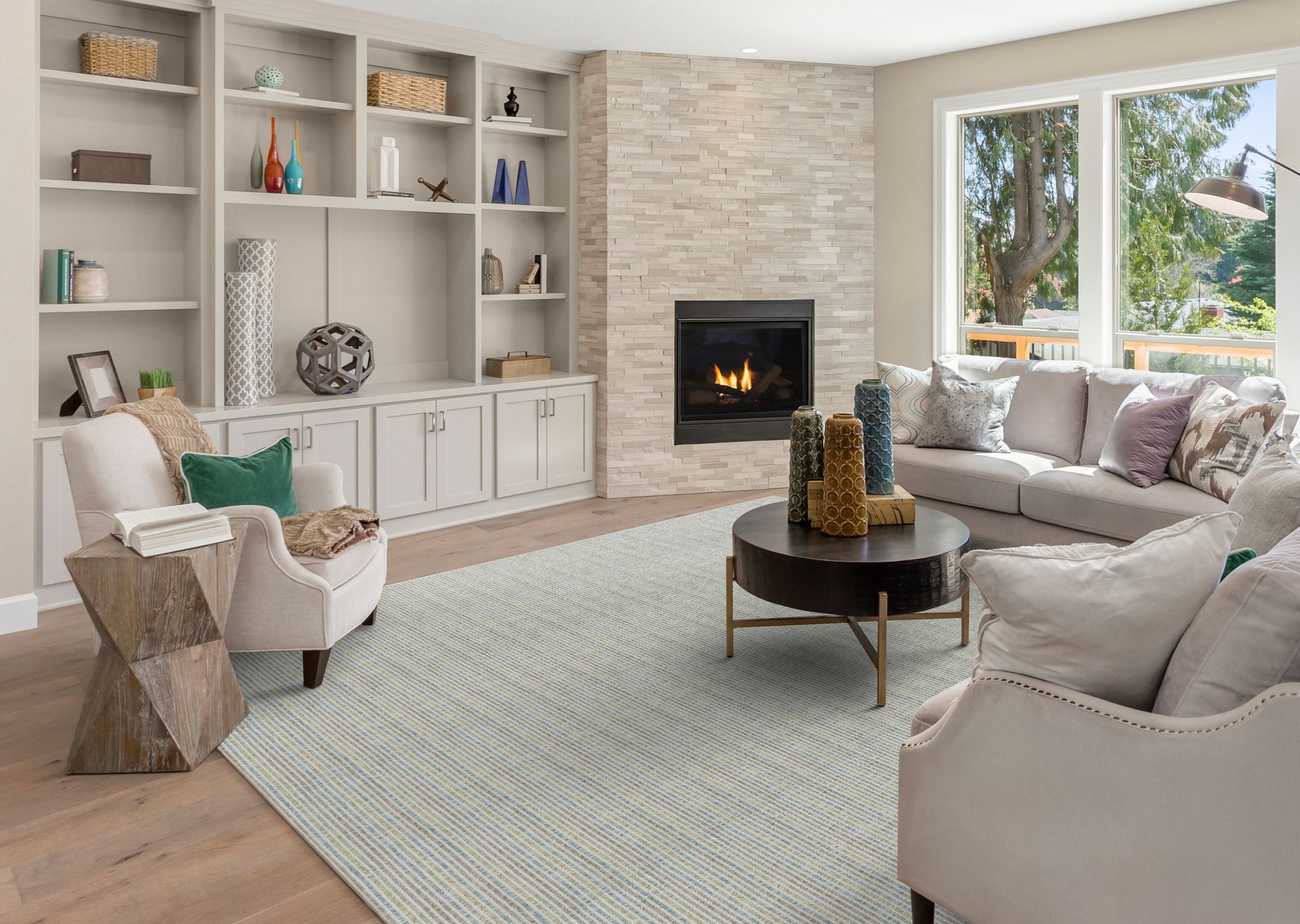 Cozy living room with built-in shelves, fireplace, and neutral-toned furniture.