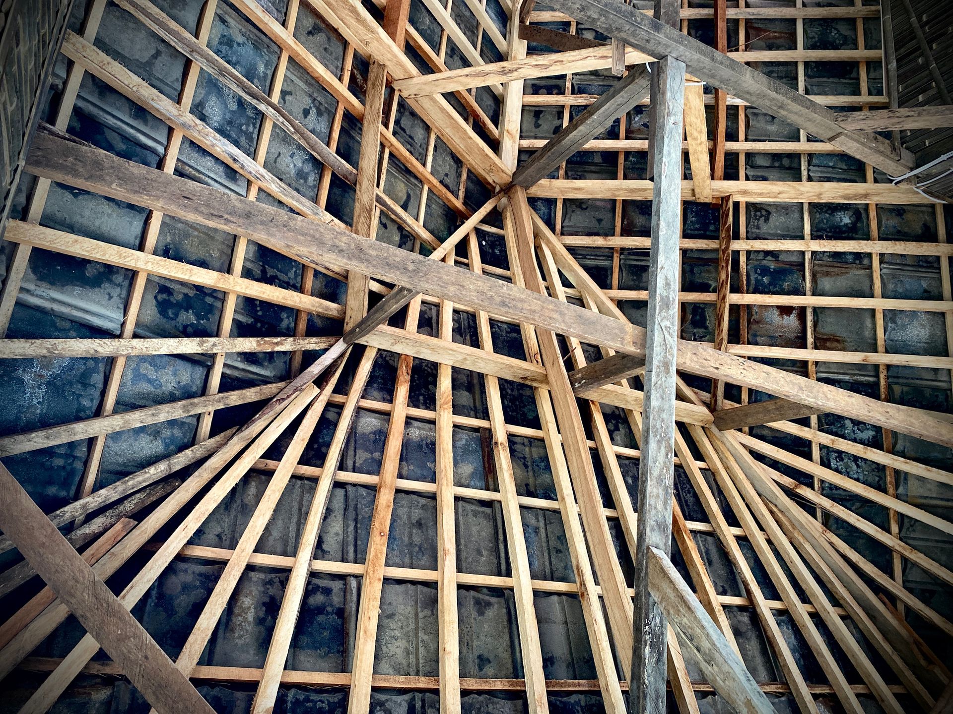 Wooden roof truss structure under construction by trusted truss suppliers for strong support. Wooden roof truss structure under construction by trusted truss suppliers for strong support.